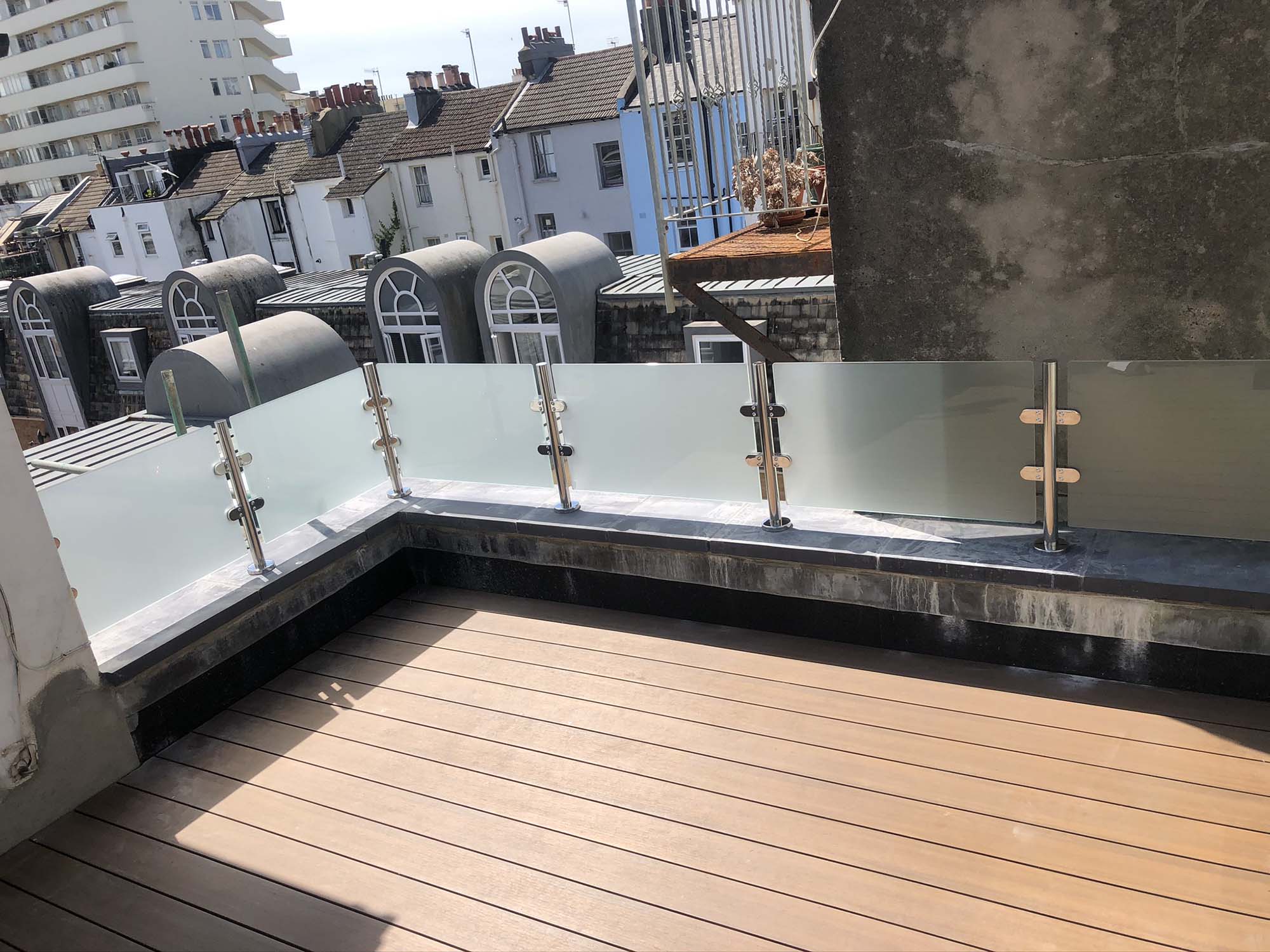Glass and metal balustrade on rooftop balcony in Sussex