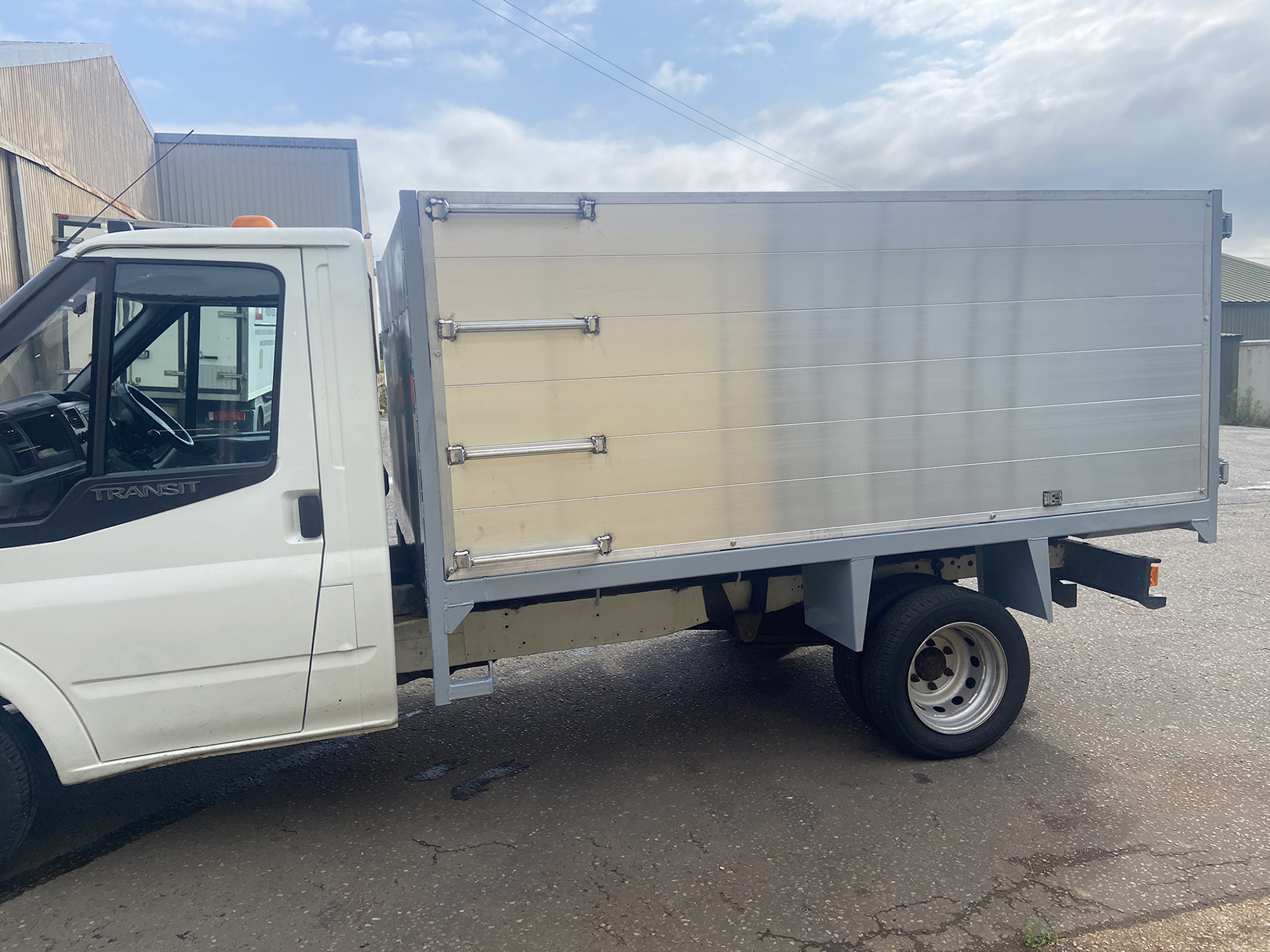 Side view of ladder on silver tipper body trailer on Merc van