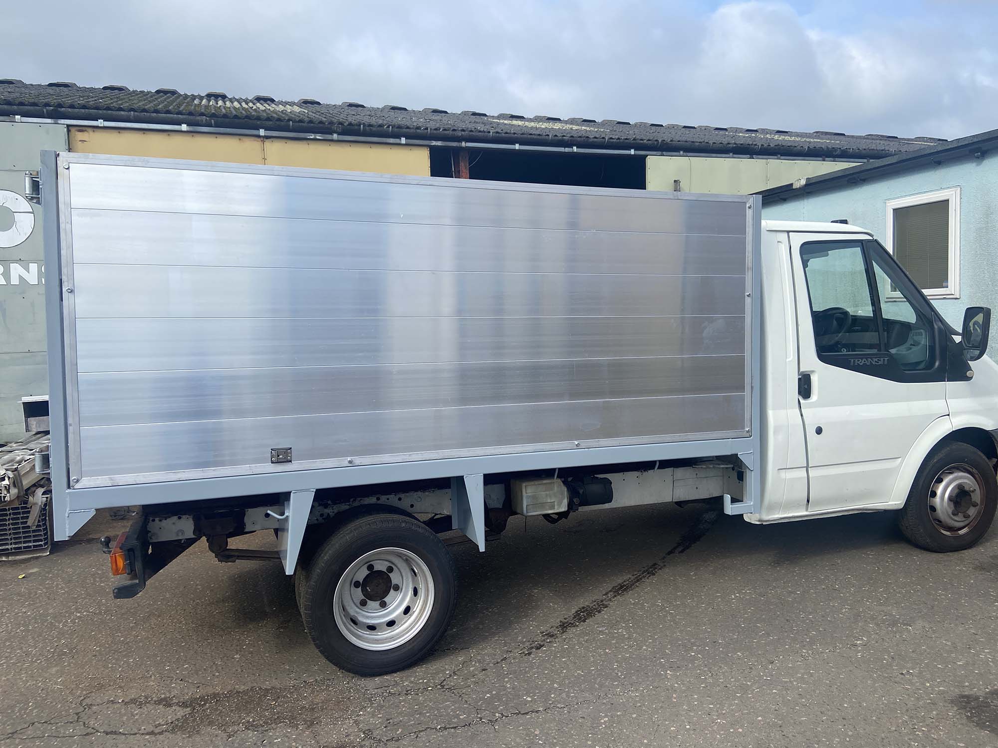 Side view of ladder on silver tipper body trailer on Merc van