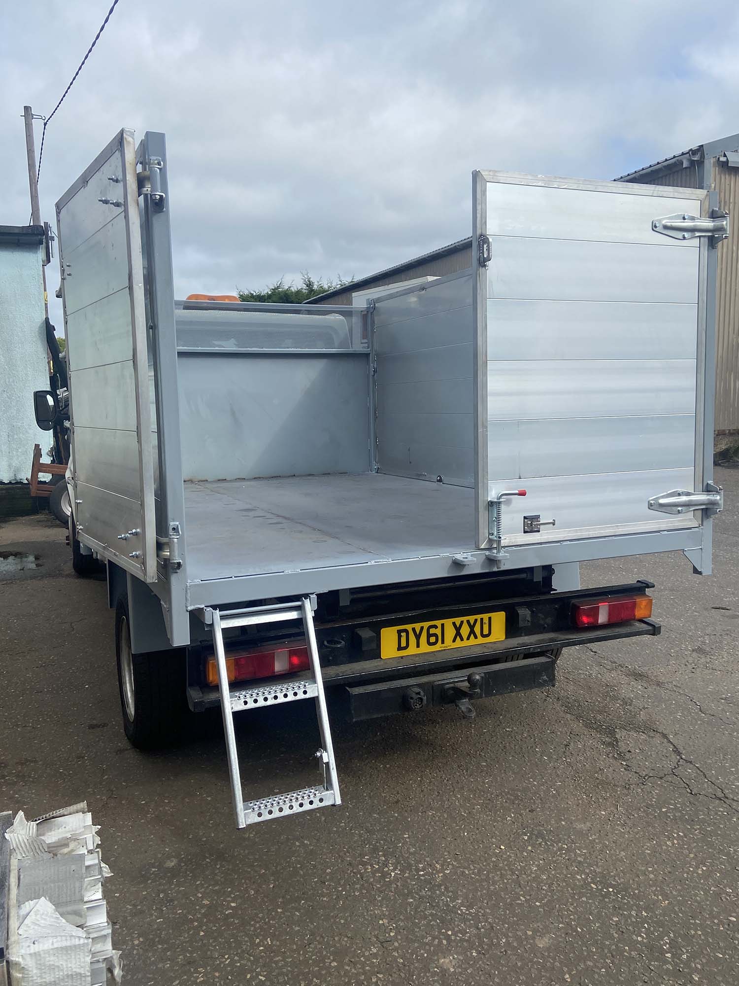back view of ladder on silver tipper body trailer on Merc van